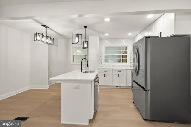 a kitchen with stainless steel appliances granite countertop a sink a stove and refrigerator