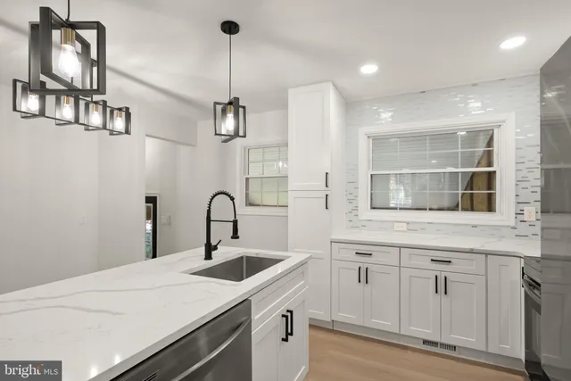 a kitchen with a sink a counter space and a window