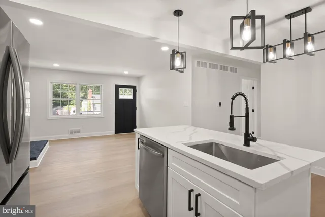 a kitchen with stainless steel appliances a refrigerator sink and microwave