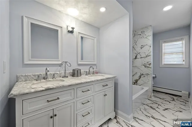 a spacious bathroom with a granite countertop sink a toilet and a mirror