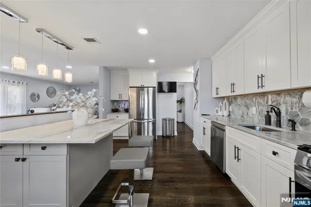 a kitchen with white cabinets sink and white appliances