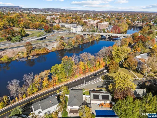 an aerial view of lake and residential houses with outdoor space