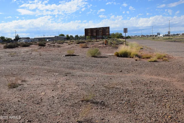 a view of a yard with wooden fence