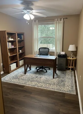 a living room with furniture rug and window