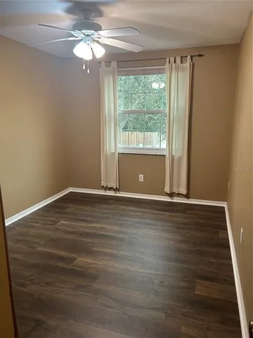 a view of room with window and ceiling fan