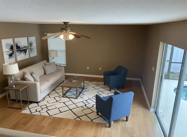 a living room with furniture and a chandelier