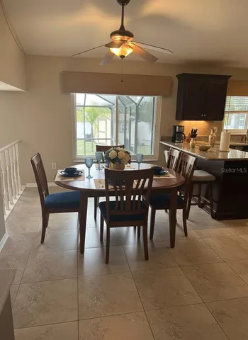 a view of a dining room with furniture window and outside view