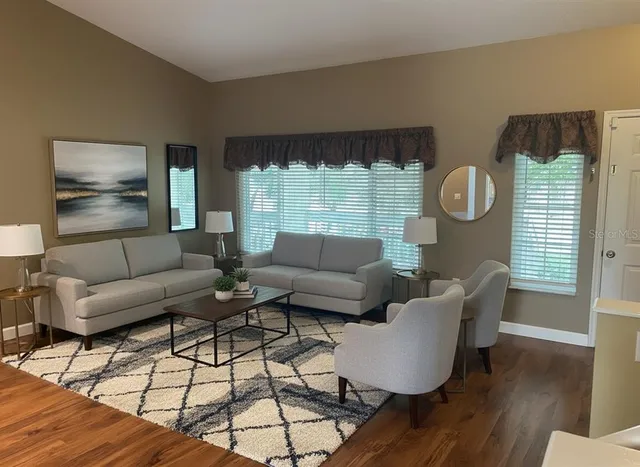 a living room with furniture and a large window