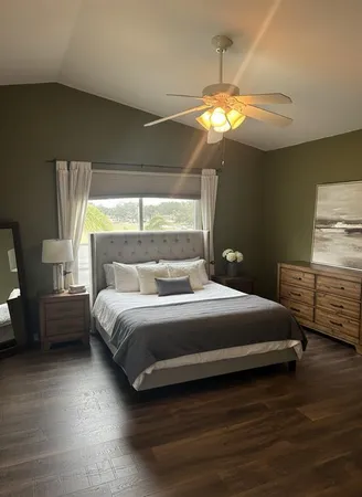 a bedroom with a bed and a chandelier