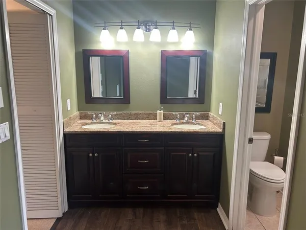 a bathroom with a double vanity sink and a mirror