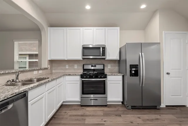 a kitchen with a sink stove and refrigerator