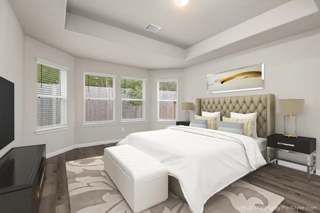 a bedroom with a bed and wooden floor