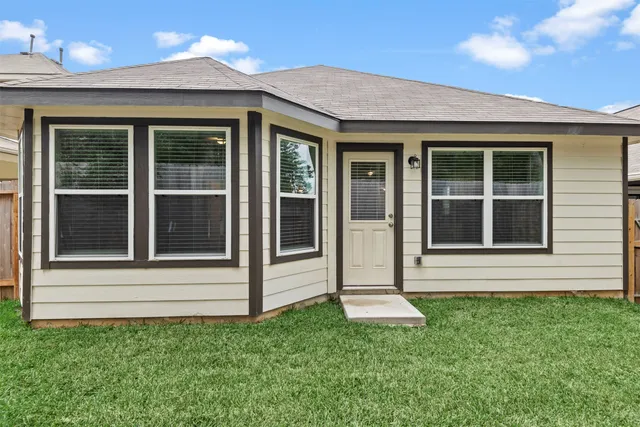 a view of house with yard