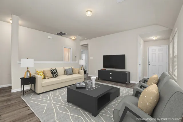 a living room with furniture and a flat screen tv