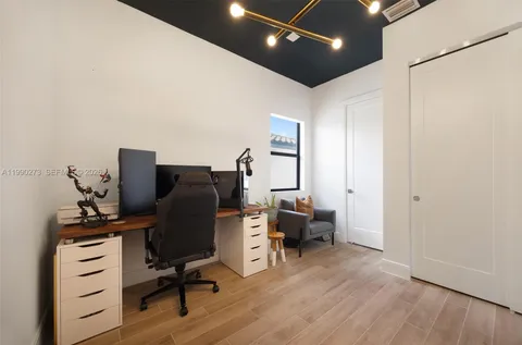 a view of workspace with wooden floor windows