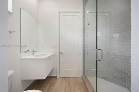 a bathroom with a sink a mirror and shower