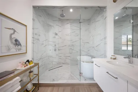 a bathroom with a double vanity sink mirror and bathtub
