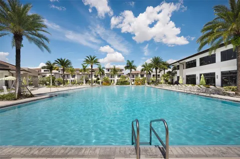 a view of a house with swimming pool and sitting area