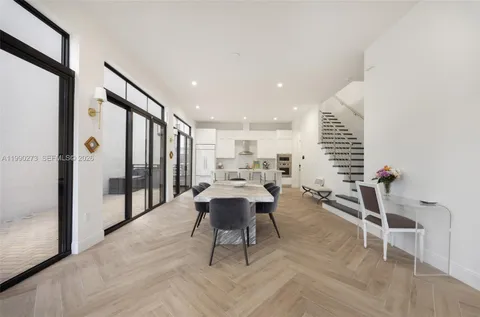 a living room with furniture a rug and a table