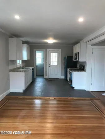 a view of a kitchen with sink and cabinets