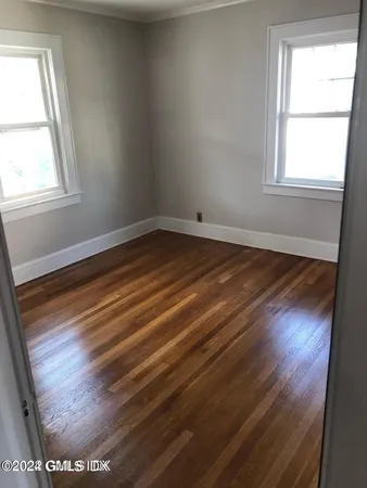 an empty room with wooden floor