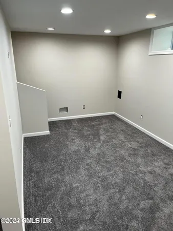a white toilet sitting next to a bath tub