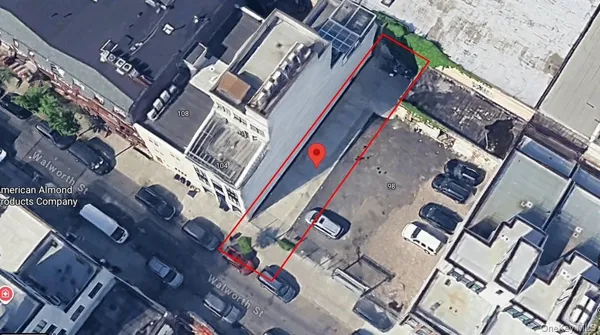 a view of a house with a small yard and wooden fence