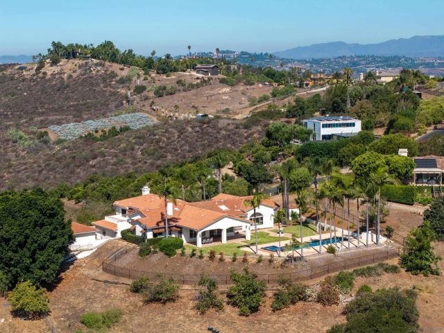 an aerial view of a house with a lot of trees