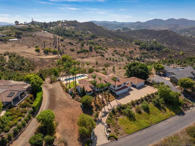 an aerial view of residential house with green space