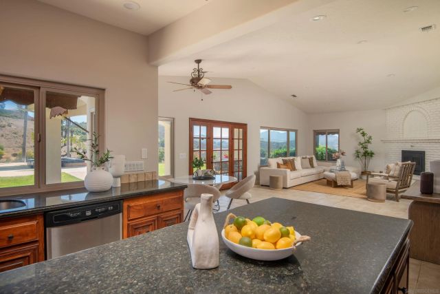 a living room with furniture a rug and a floor to ceiling window