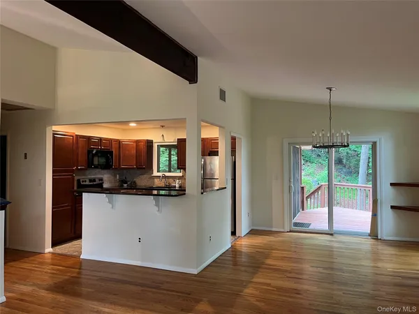 a view of a small space with wooden floor and a window