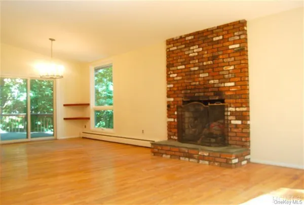 a view of a small space with wooden floor and a window