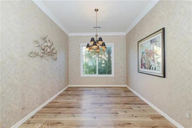 a hallway with a window and wooden floor