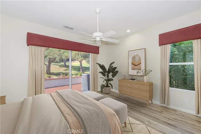 a bedroom with a large bed and a large window