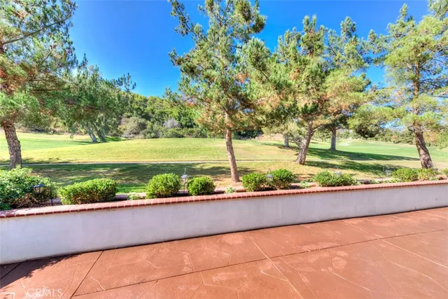 a view of a balcony with yard