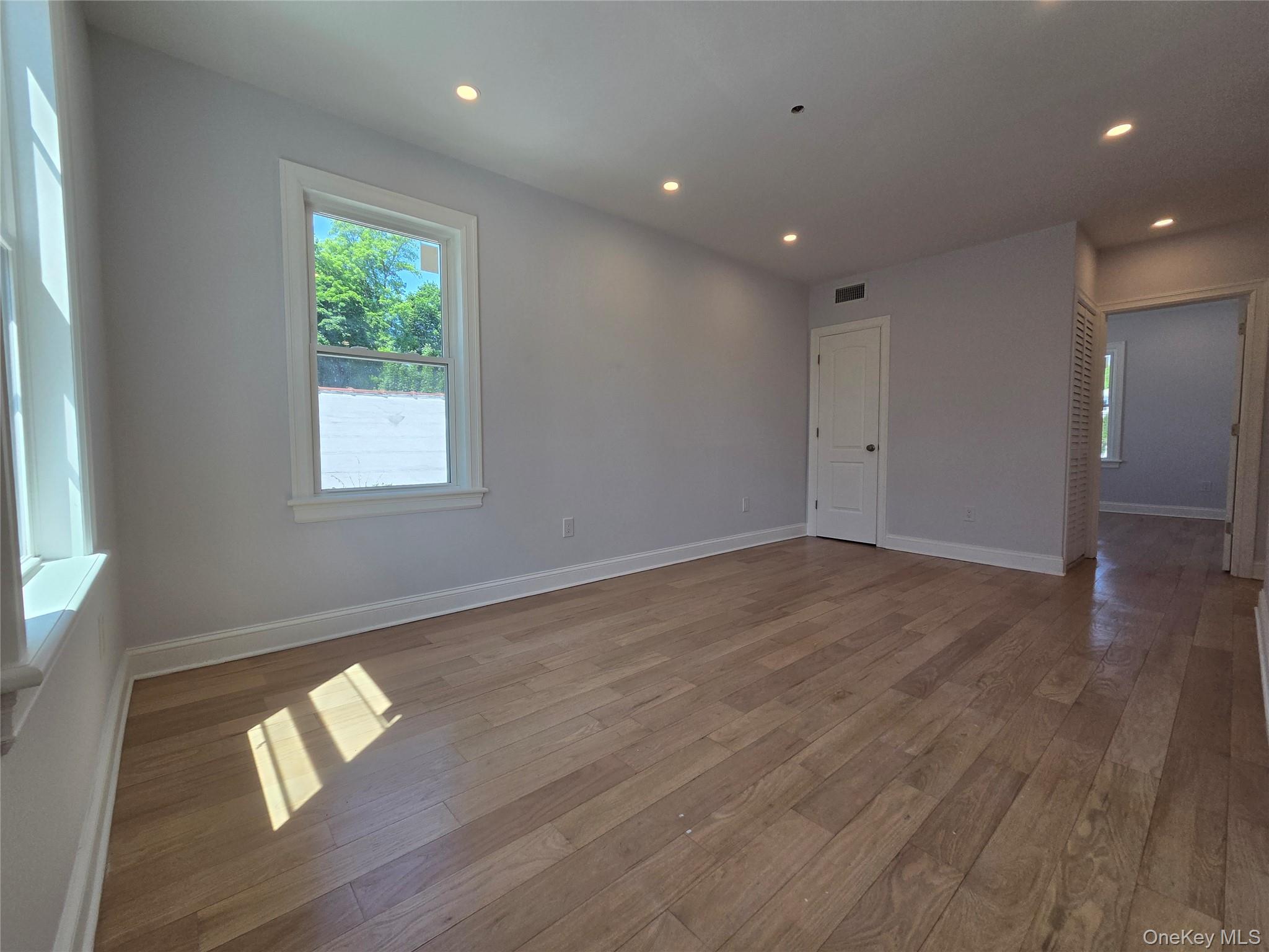 965 Main Street, Unit 2 New Rochelle, NY 10801 - Photo 6 of 12 Spacious room featuring wood-finish flooring, recessed lighting, and white baseboards