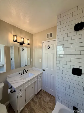 a spacious bathroom with a sink and a mirror