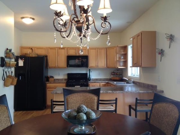 8 Charles Ridge Road, Unit C802 Littleton, MA 01460 - Photo 11 of 30 a kitchen with stainless steel appliances granite countertop a sink dishwasher a stove a refrigerator a microwave oven with cabinets and wooden floor