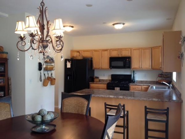 8 Charles Ridge Road, Unit C802 Littleton, MA 01460 - Photo 10 of 30 a kitchen with a table and chairs in it