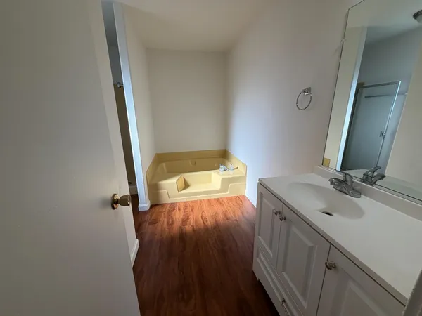 a view of a big room with wooden floor closet and windows