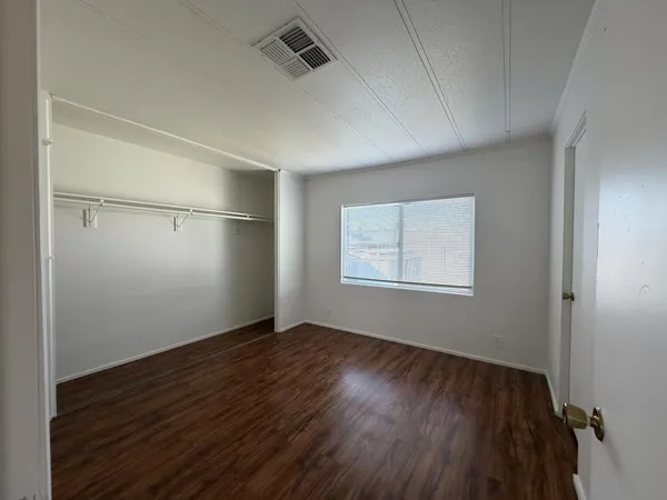 a view of room with window and wooden floor