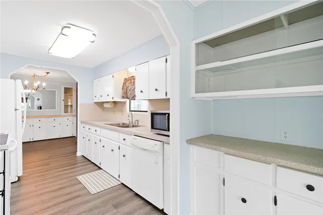 a kitchen with cabinets and wooden floor