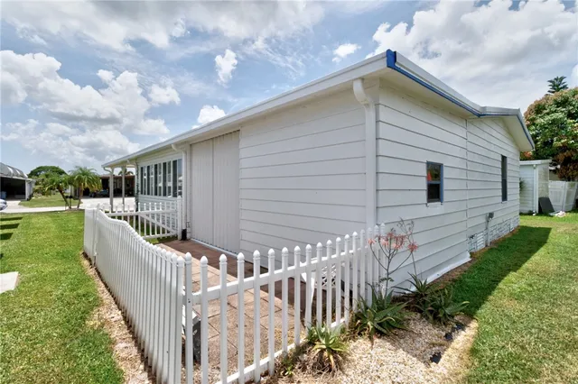 a view of a house with backyard and porch