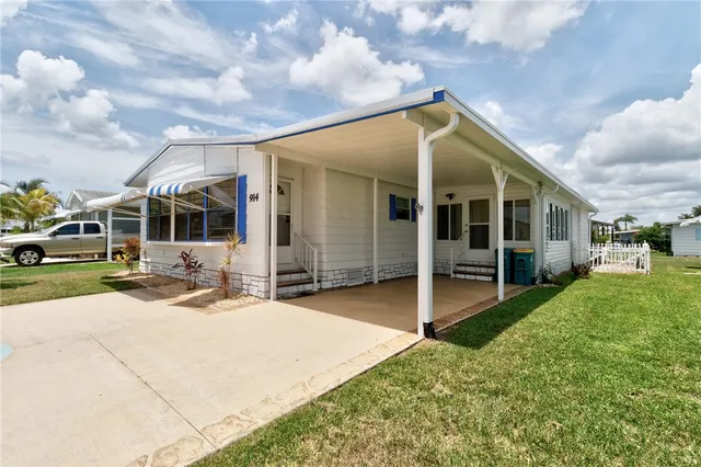 a view of a house with backyard porch and sitting area