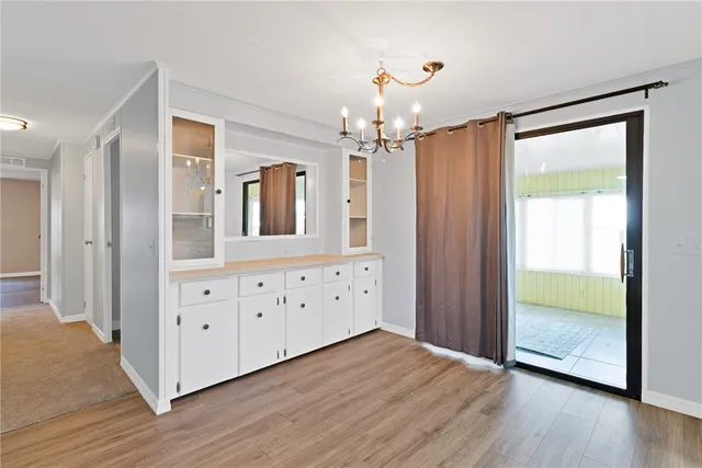 a view of a hallway with wooden floor and front door