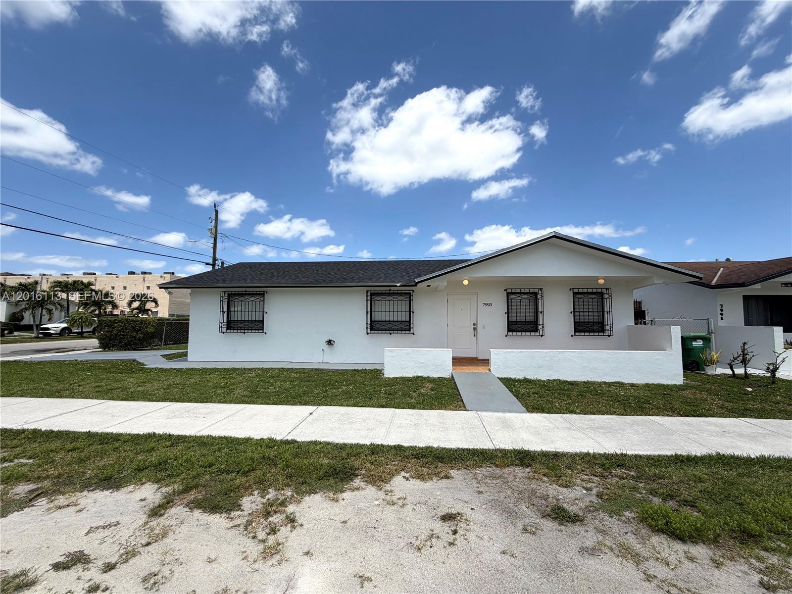 7993 Southwest 9th Terrace Miami, FL 33144 - Photo 11 of 18 a front view of a house with a yard and garage