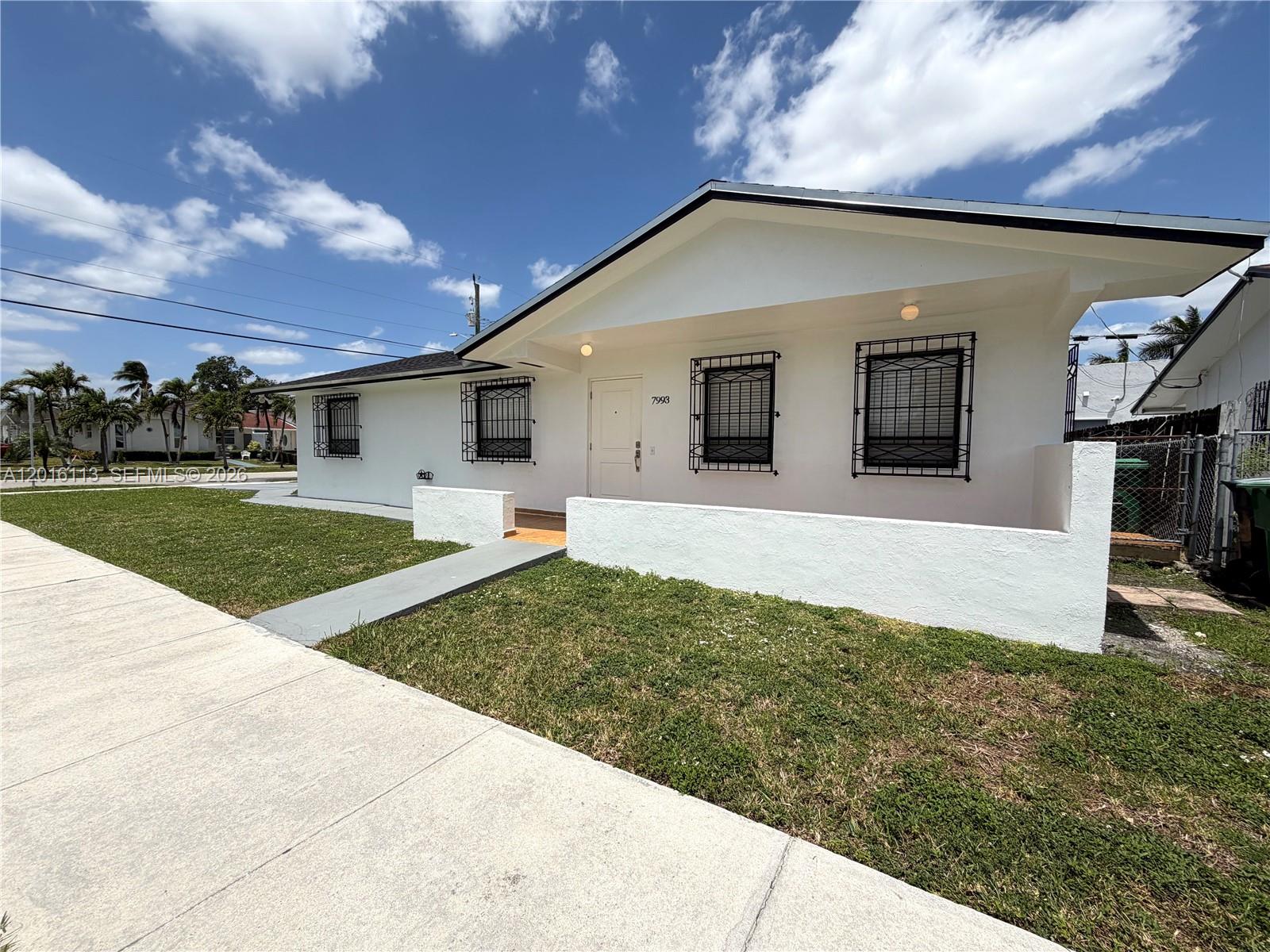 7993 Southwest 9th Terrace Miami, FL 33144 - Photo 12 of 18 a front view of a house with a yard