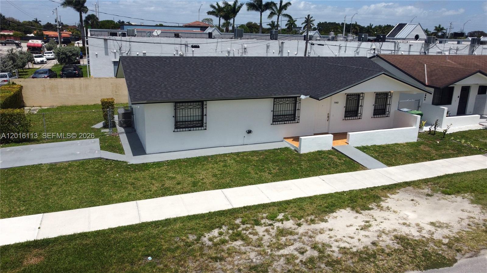 7993 Southwest 9th Terrace Miami, FL 33144 - Photo 14 of 18 front view of house with a yard