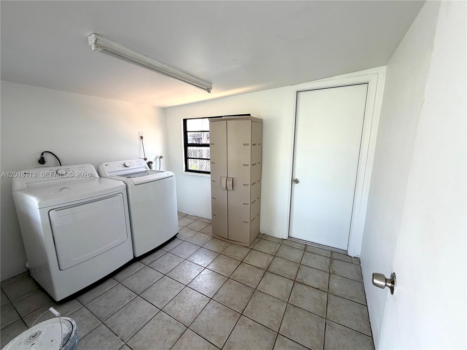7993 Southwest 9th Terrace Miami, FL 33144 - Photo 4 of 18 a view of a storage & utility room with closet dryer