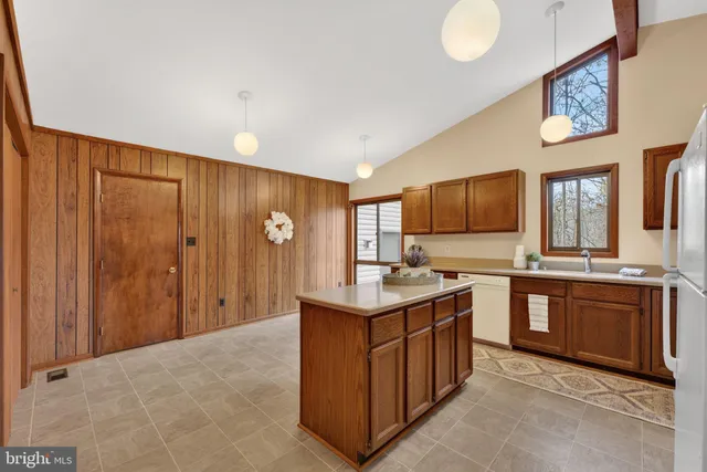 a kitchen with stainless steel appliances granite countertop a refrigerator a sink and a stove